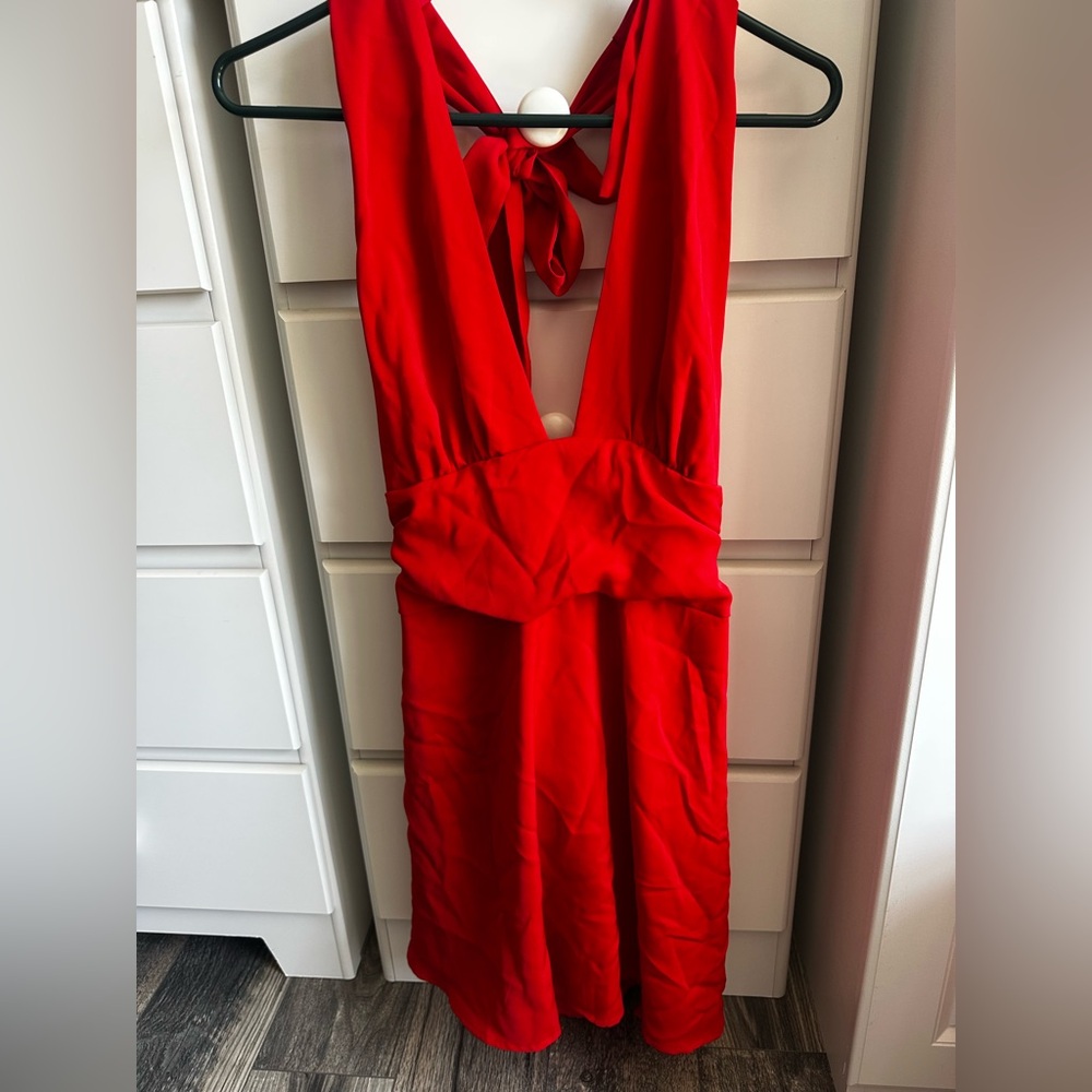 Red dress. Backless with a tie back. Zipper on side.